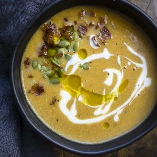 creamy roasted butternut squash soup with pepitas, crema and olive oil
