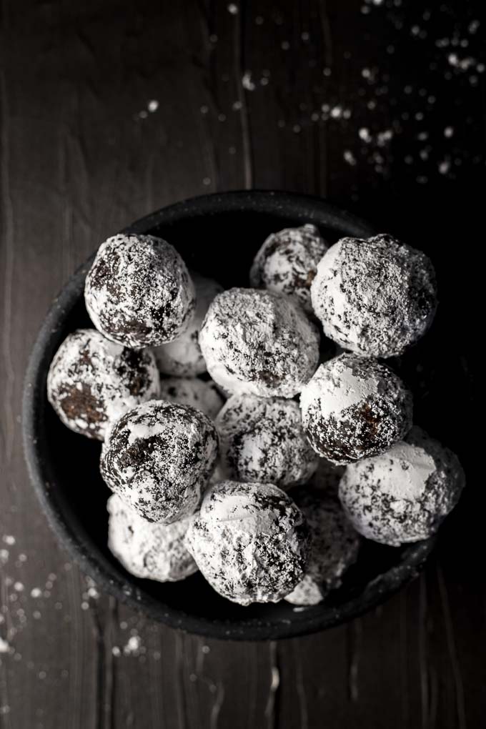 bowl of powdered sugar covered chocolate truffles