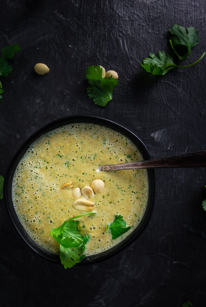peanut sauce garnished with peanuts and cilantro with a spoon