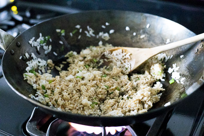 fried rice being cooked in a wok