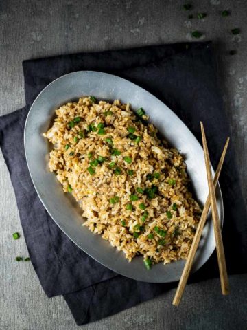 plate of fried rice with chopsticks