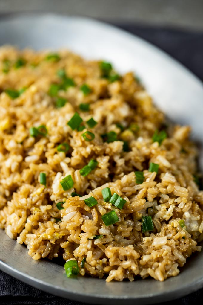 plate of fried rice with green onions