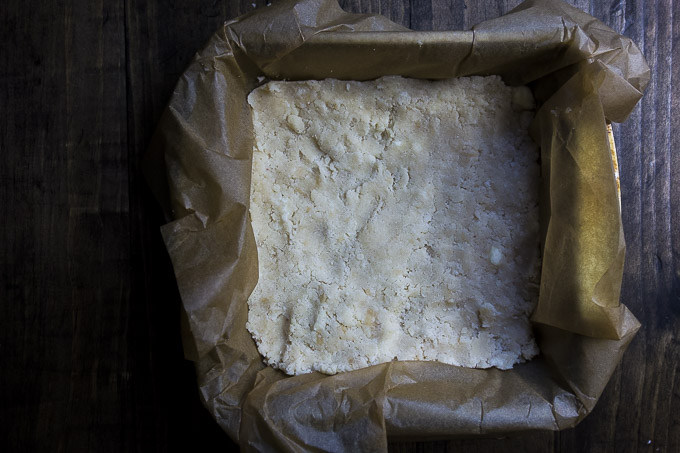 shortbread crust in a parchment paper lined pan