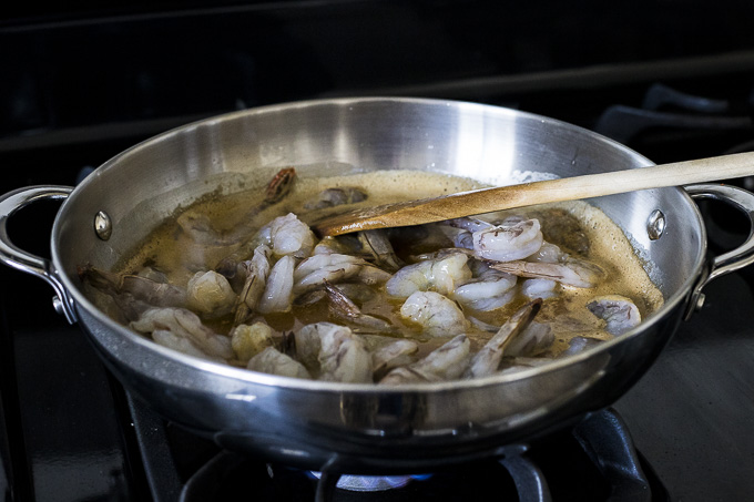 raw shrimp in a skillet with butter