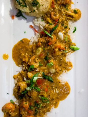 best cajun food in downtown san diego, crawfish etouffee over rice on a plate with cajun potato salad