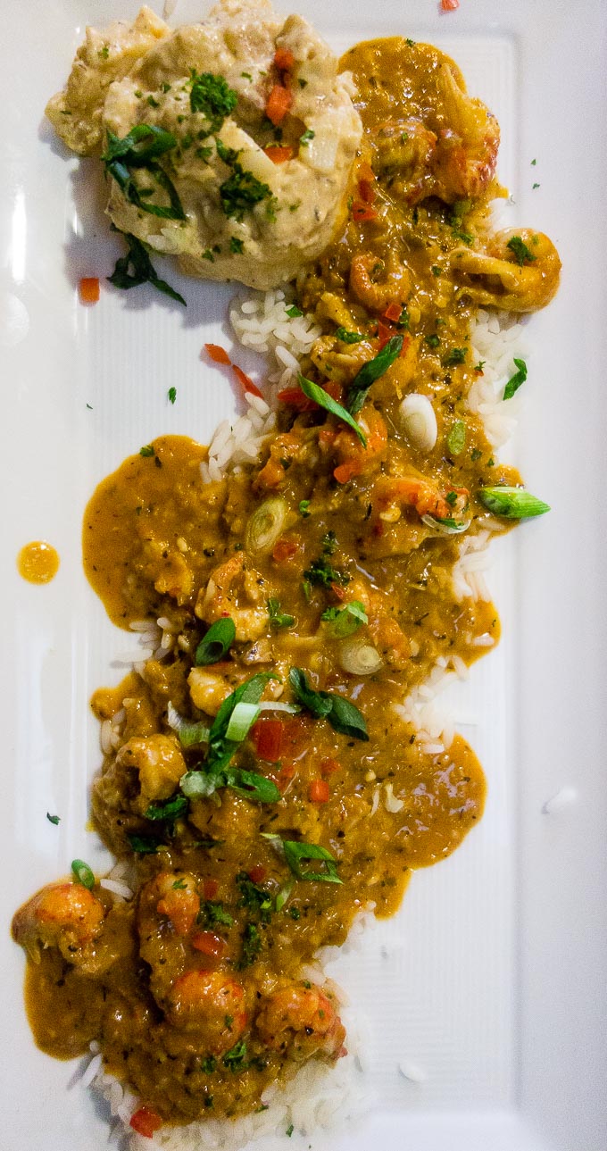 best cajun food in downtown san diego, crawfish etouffee over rice on a plate with cajun potato salad