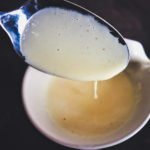 a spoon covered with blender hollandaise sauce