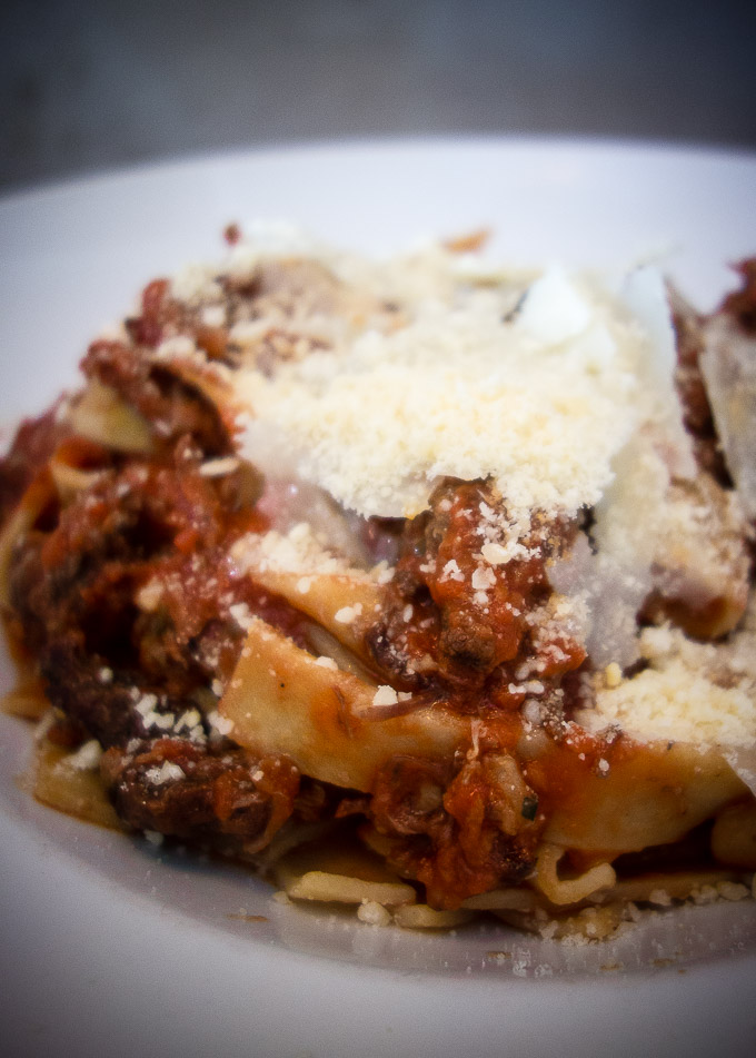 fresh pappardelle pasta with braised beef bolognese sauce topped with parmesan cheese, civico 1845