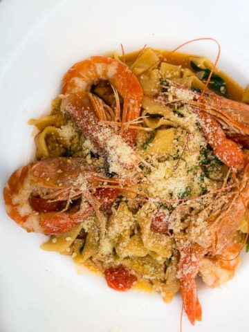 pasta with fresh prawns, parmesan cheese and tomatoes on plate, civico 1845