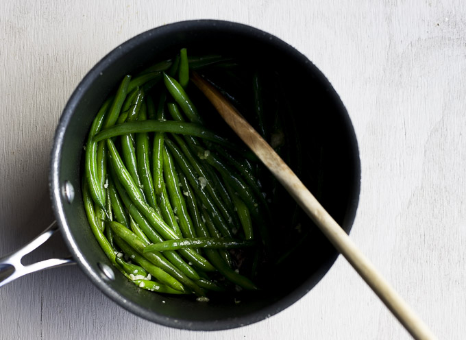 green beans and garlic in a saucepan