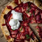 sliced strawberry galette topped with vanilla ice cream