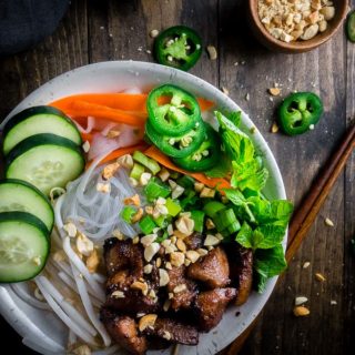 vietnamese pork noodle bowl with fresh veggies and herbs