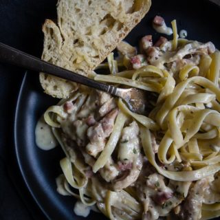 plate of pasta with chicken ham and cream sauce