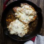onion and cheese smothered pork chops i a skillet