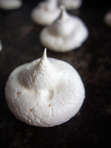 close up of meringue cookie on baking sheet