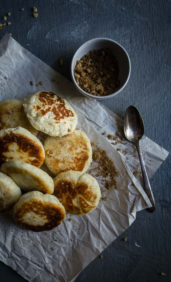 sweet korean pancakes on parchment paper with spoon and walnuts