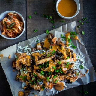 korean beef nachos with cheese sauce and kimchi