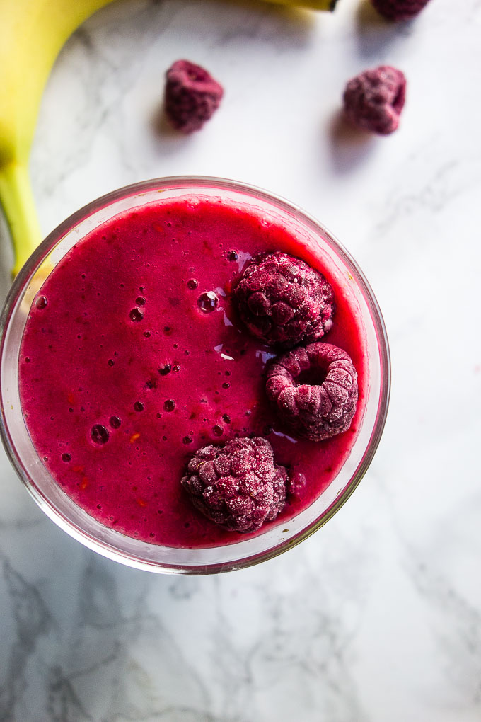 red smoothies with raspberries on top