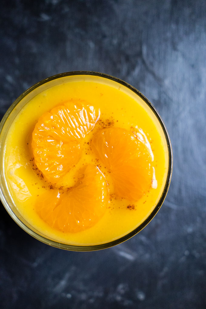 orange smoothie with orange sections and mango