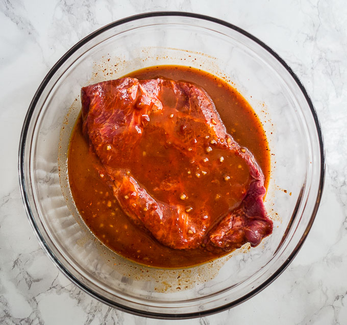 steak in a red marinade