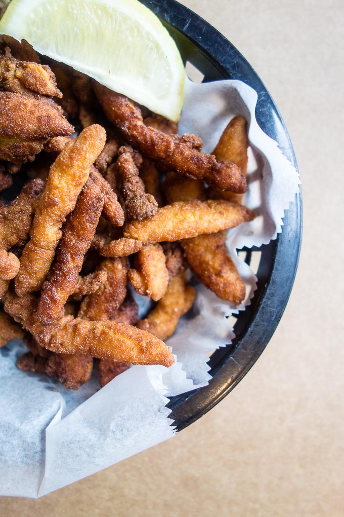 close up of fried clam strips in a basket