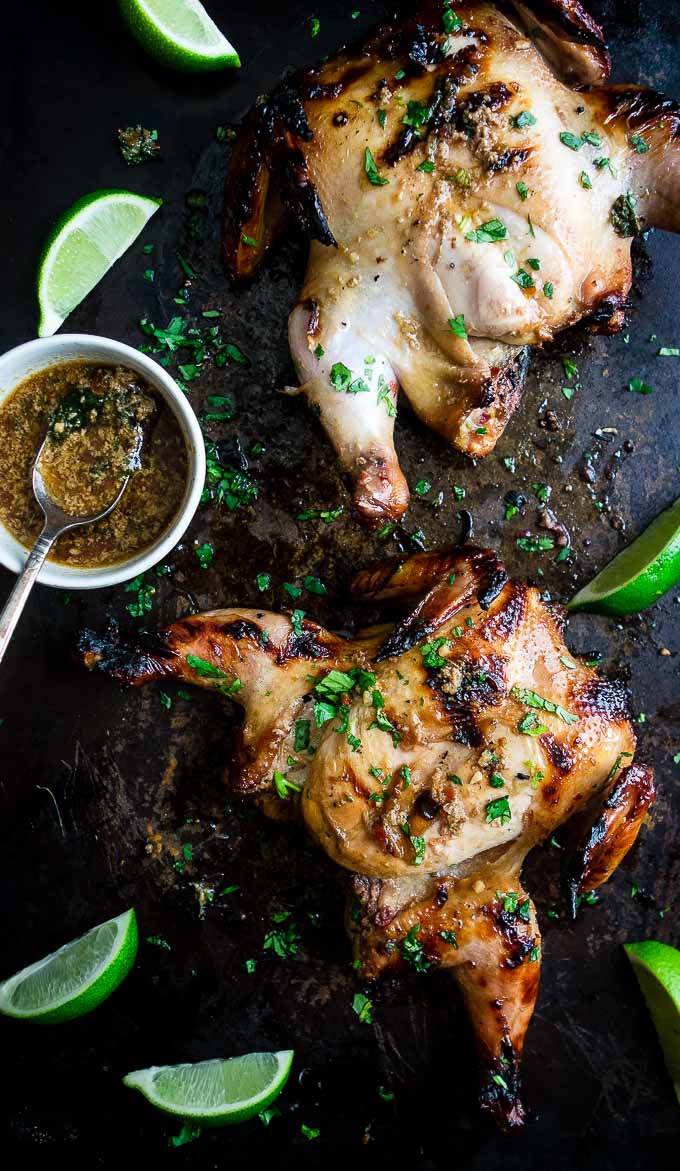 2 cornish game hens covered in sauce and cilantro with lime