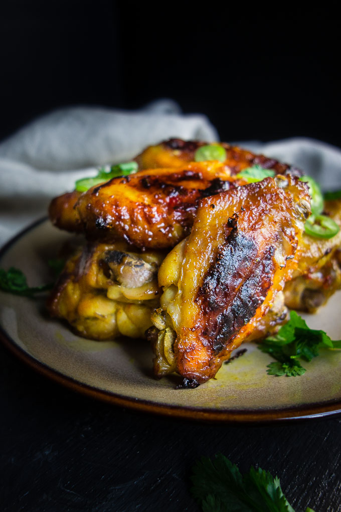 golden brown baked chicken wings on a plate