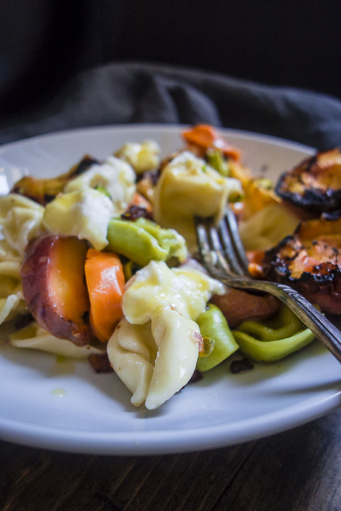 grilled peach tortellini salad with fork