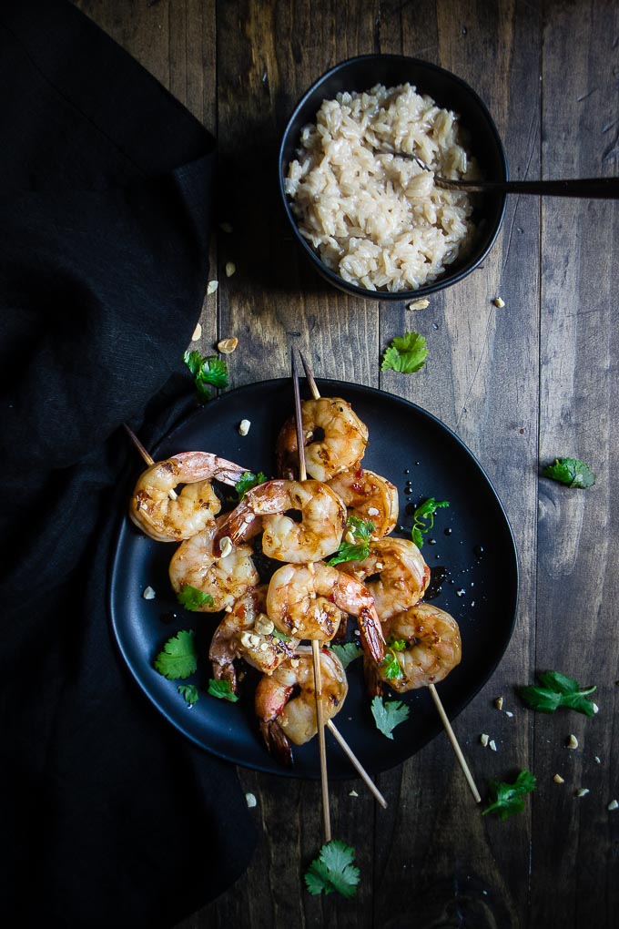 grilled shrimp on a skewer with cilantro and rice