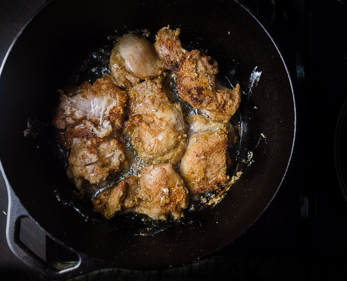 chicken frying in a skillet
