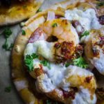 brazilian pizza with red pepper chimichurri sauce close up shrimp