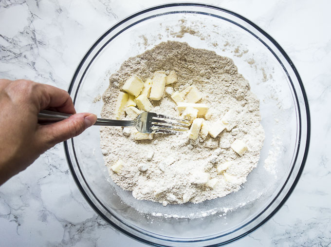 butter in flour in a bowl being cut