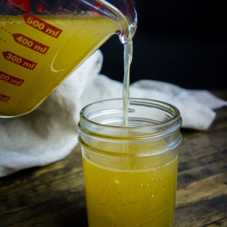 a pour shot of turkey bone broth food photography