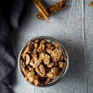 pecans in a dish garnished with cinnamon