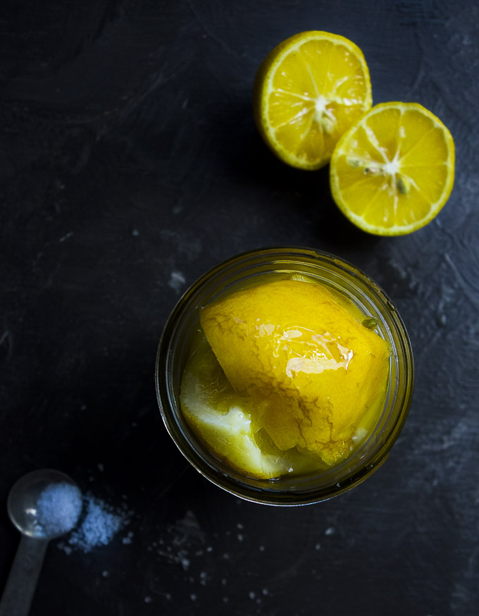 jar of preserved lemons garnished with lemons