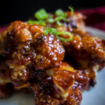 close up of spicy korean cauliflower wings on a plate