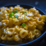 close up of cheesy thai red curry mac and cheese in a bowl