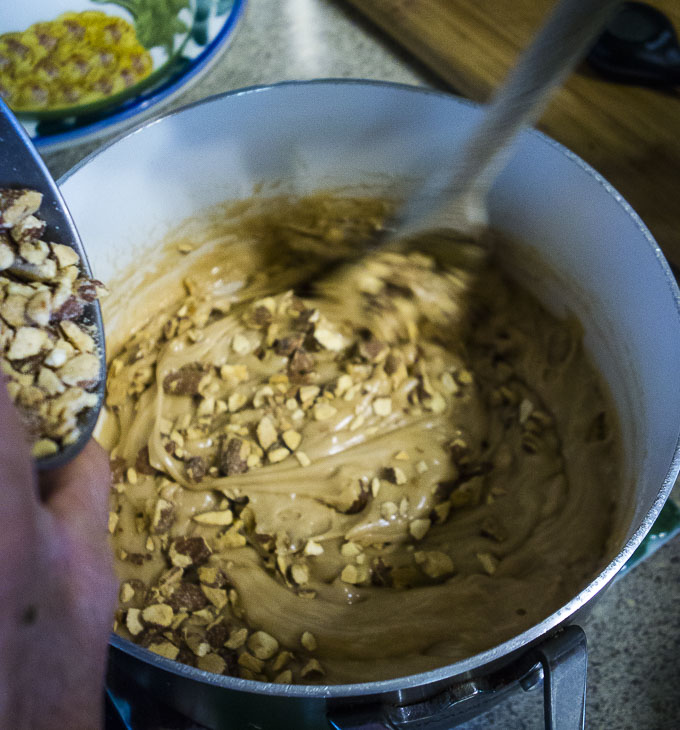 mixing almonds into buttercrunch candy