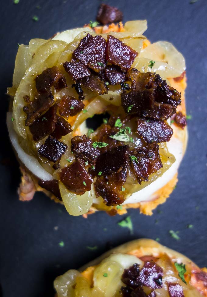close up of mini bagel bites topped with bacon and apple
