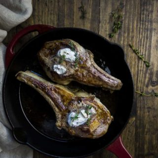 veal chops in a skillet with truffle butter