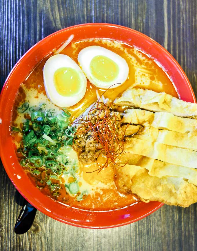 bowl of ramen with fried pork cutlets and 2 eggs