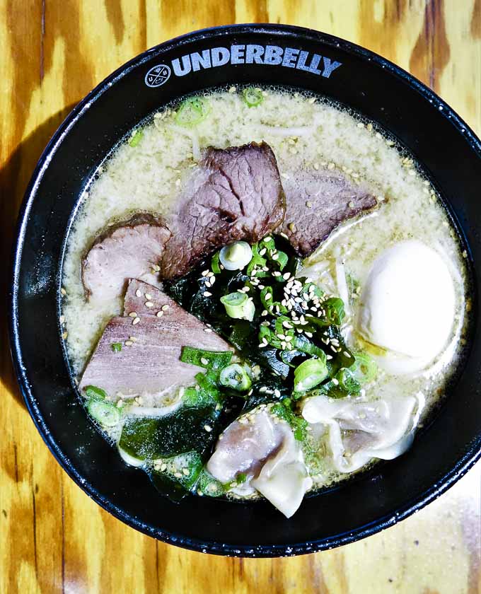 bowl of ramen with difefrent meats and seaweed