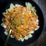 hungarian chicken paprikash in a bowl with a spoon