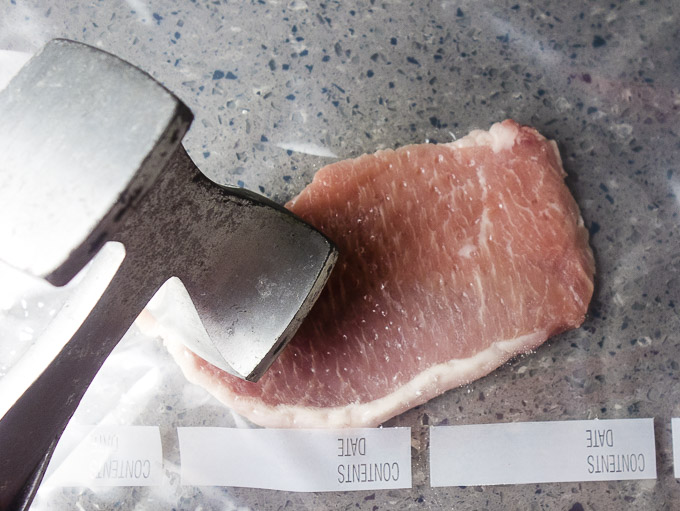 tenderizing pork cutlets with a meat tenderizer