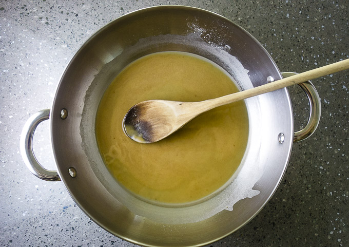 roux (flour and oil) in a skillet with wooden spoon
