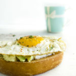 bread with avocado and a fried egg on top