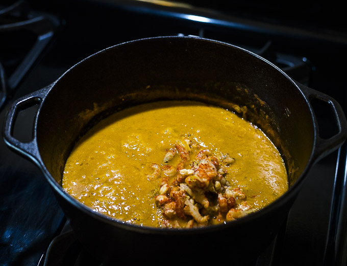 crawfish added to orange soup