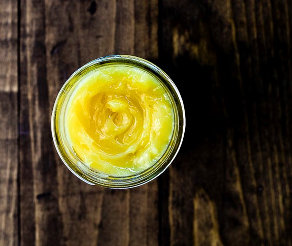 top down photo of lemon curd in a glass jar