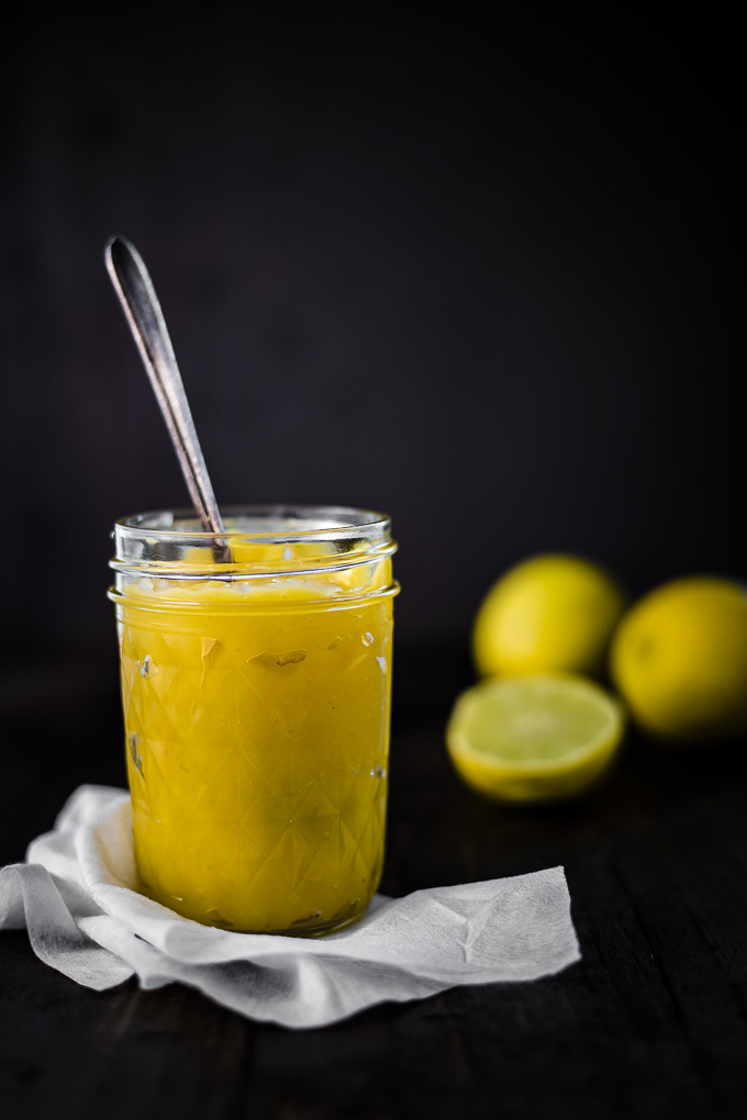lemon curd in a glass jar with a spoon