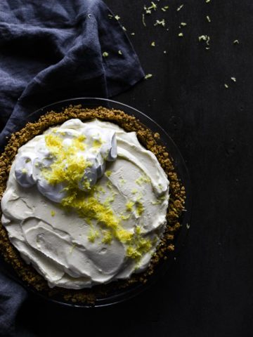 lemon pie with whipped cream and lemon zest on top